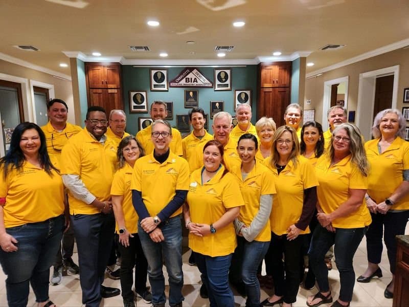 Quality-Crete team in matching yellow shirts at a community event
