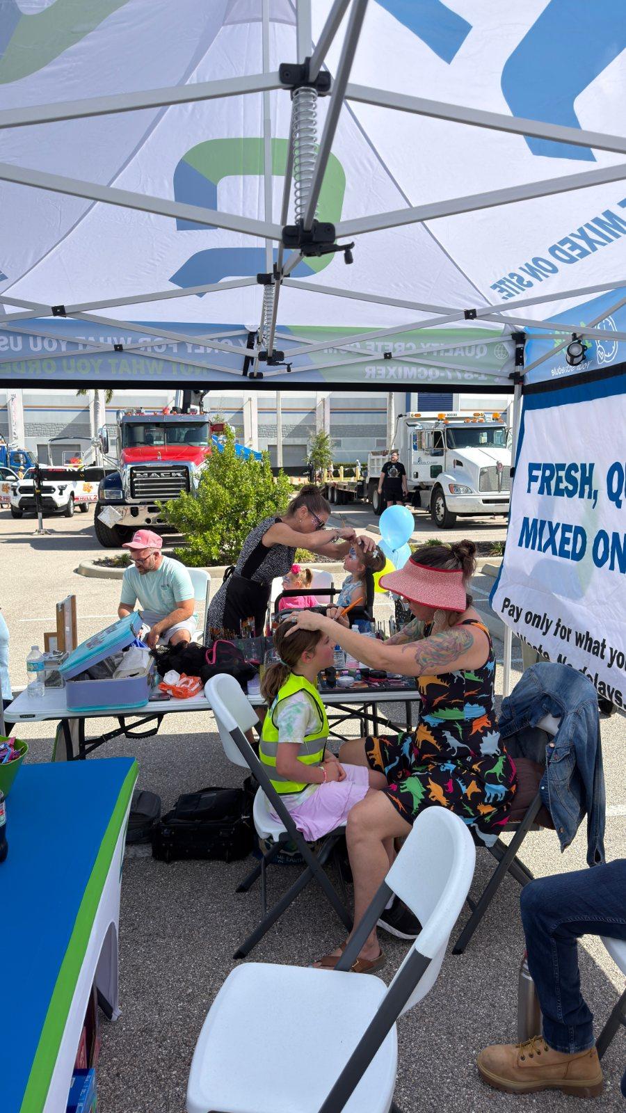 Families at the Quality-Crete tent