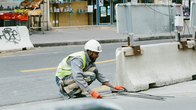 Worker finishing a municipal curb section