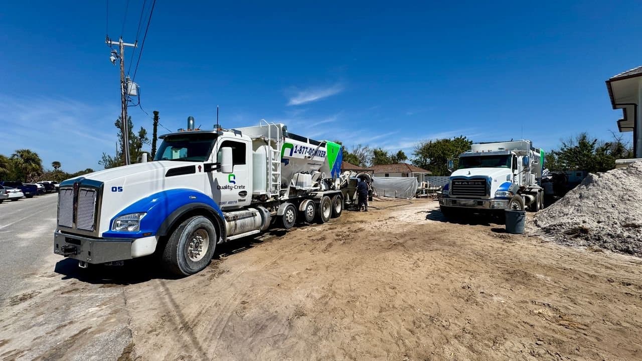 Quality-Crete volumetric mixers lined up on a jobsite