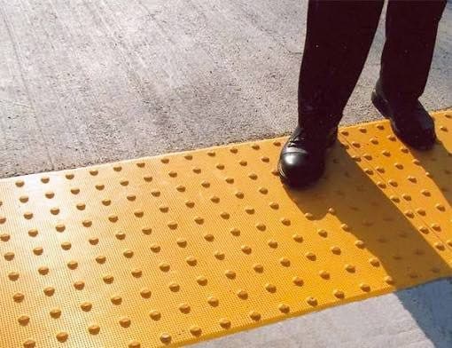 Detectable warning surface on a new sidewalk ramp