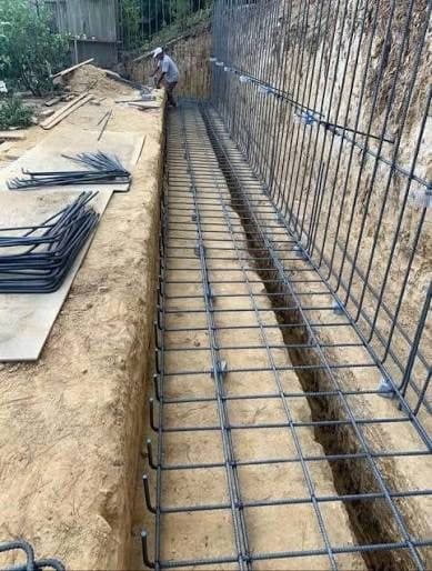 Rebar cage for a retaining wall footing