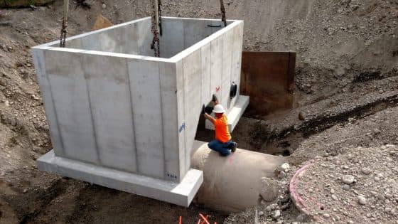 Precast utility vault lowered into an excavation