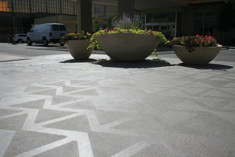 Decorative patterned concrete plaza with planters