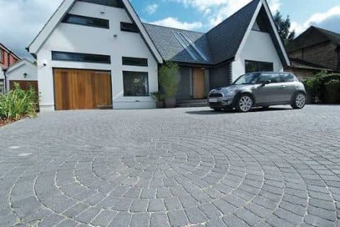Paver-pattern driveway in front of a new home